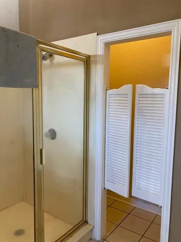 a white toilet sitting next to a white wall