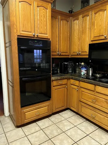 a kitchen with granite countertop cabinets stainless steel appliances and a sink