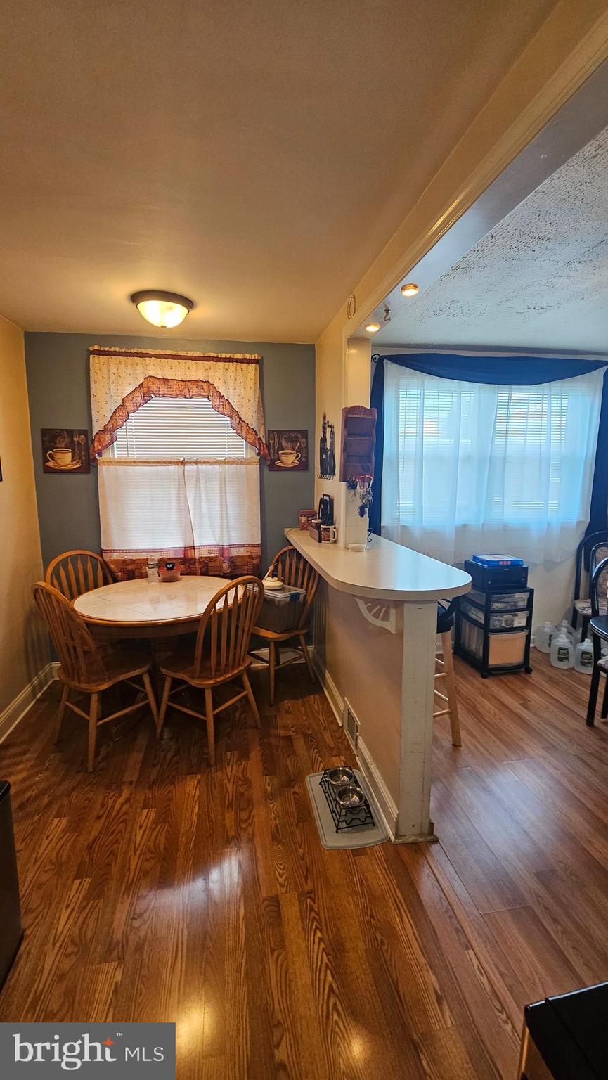 7829 Horrocks Street Philadelphia, PA 19152 - Photo 11 of 46 a dining room with a table chairs and a kitchen view