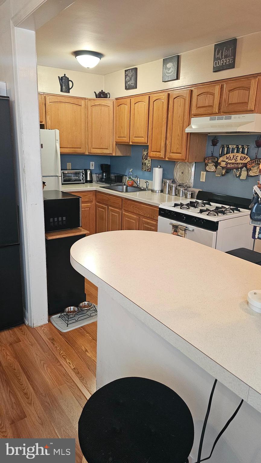 7829 Horrocks Street Philadelphia, PA 19152 - Photo 16 of 46 a kitchen with stainless steel appliances granite countertop a sink and a stove