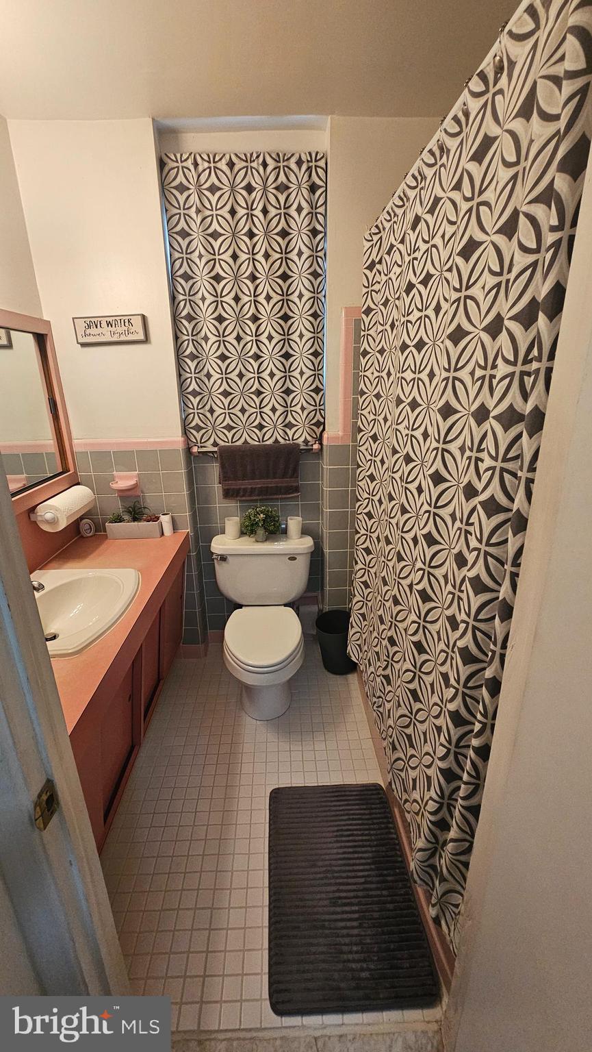 7829 Horrocks Street Philadelphia, PA 19152 - Photo 28 of 46 a bathroom with a toilet and a shower curtain