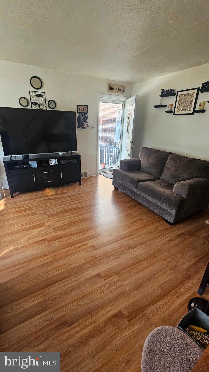 7829 Horrocks Street Philadelphia, PA 19152 - Photo 9 of 46 a living room with furniture and a flat screen tv