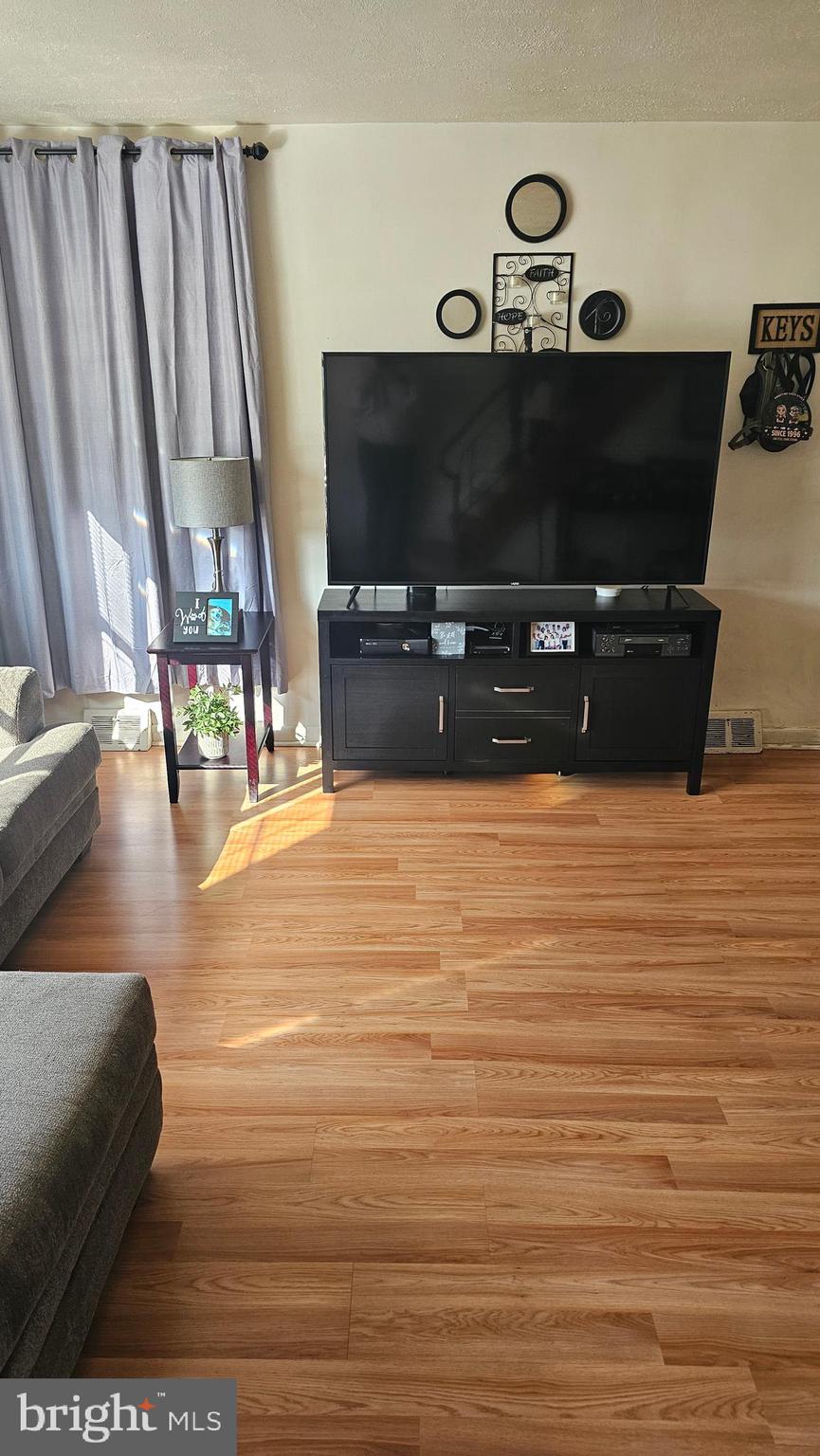 7829 Horrocks Street Philadelphia, PA 19152 - Photo 10 of 46 a living room with furniture and a flat screen tv