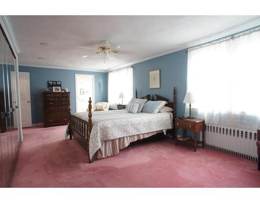 3 Helen Road Braintree, MA 02184 - Photo 9 of 18 a spacious bedroom with a bed and a chandelier