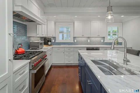 a large kitchen with a table and chairs