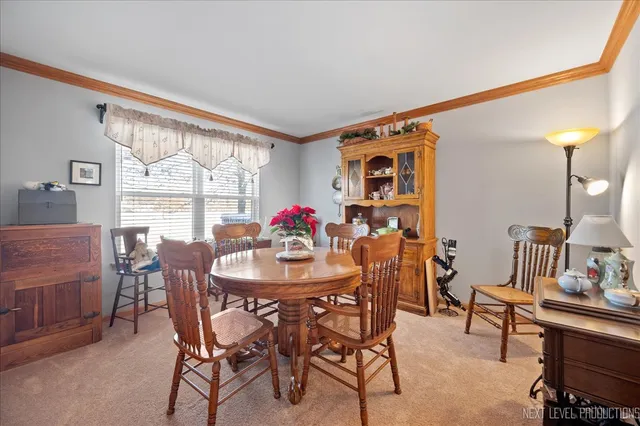 a view of a dining room with furniture and a large window
