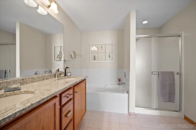 a bathroom with a granite countertop sink mirror and a bath tub