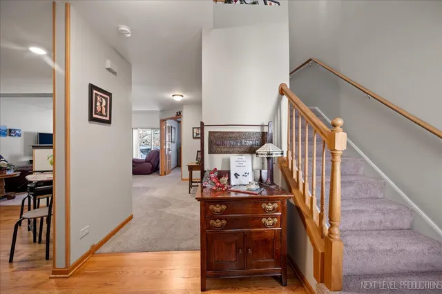 a view of a hallway with the view of living room and workspace
