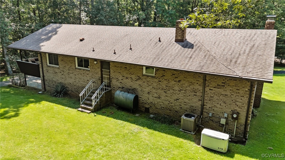 4976 Windsor Road Sandston, VA 23150 - Photo 36 of 41 Back of property featuring a chimney, oil tank, an