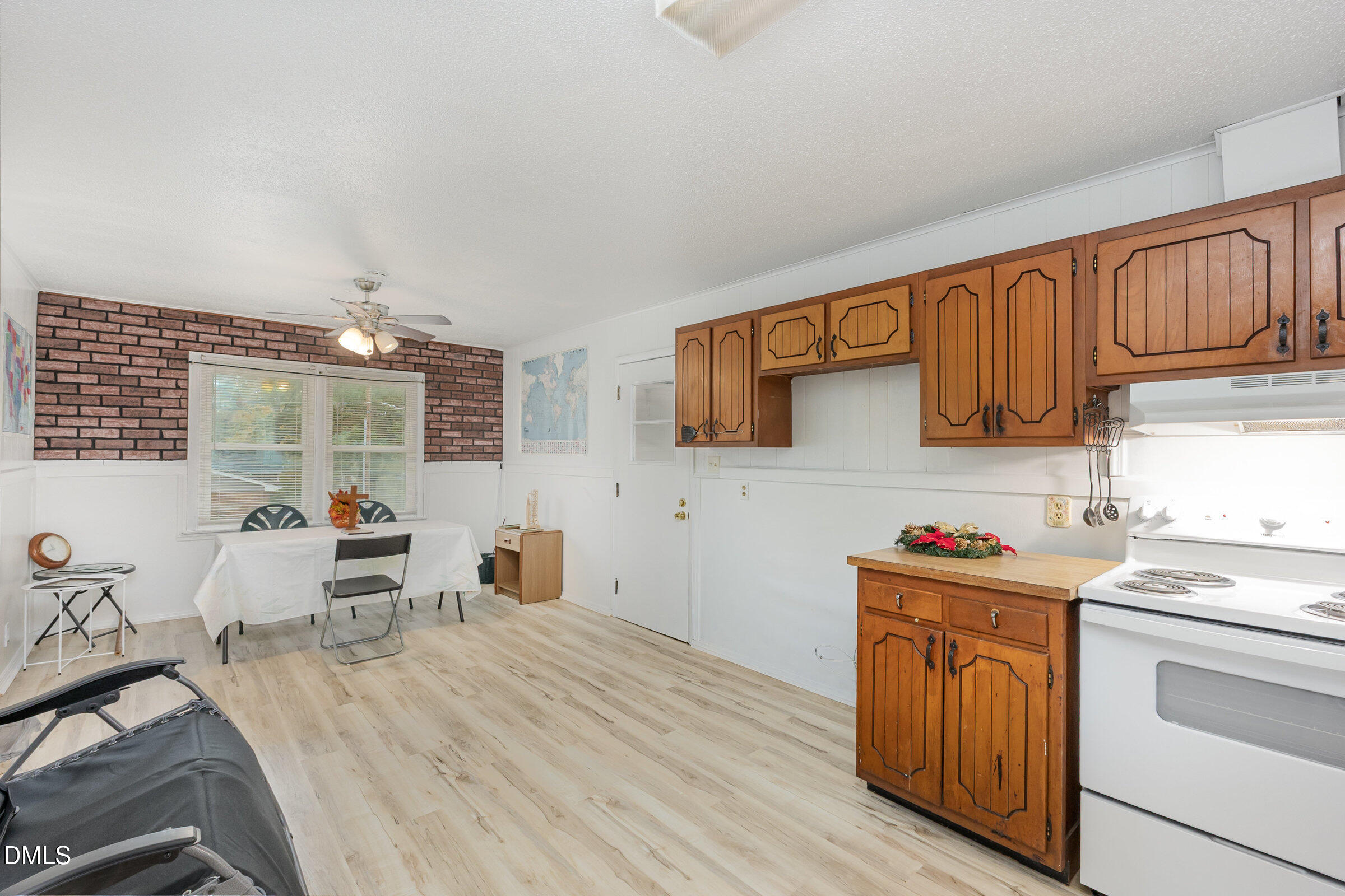 3228 Julian Drive Raleigh, NC 27604 - Photo 12 of 29 a kitchen with a sink dishwasher stove and wooden cabinets
