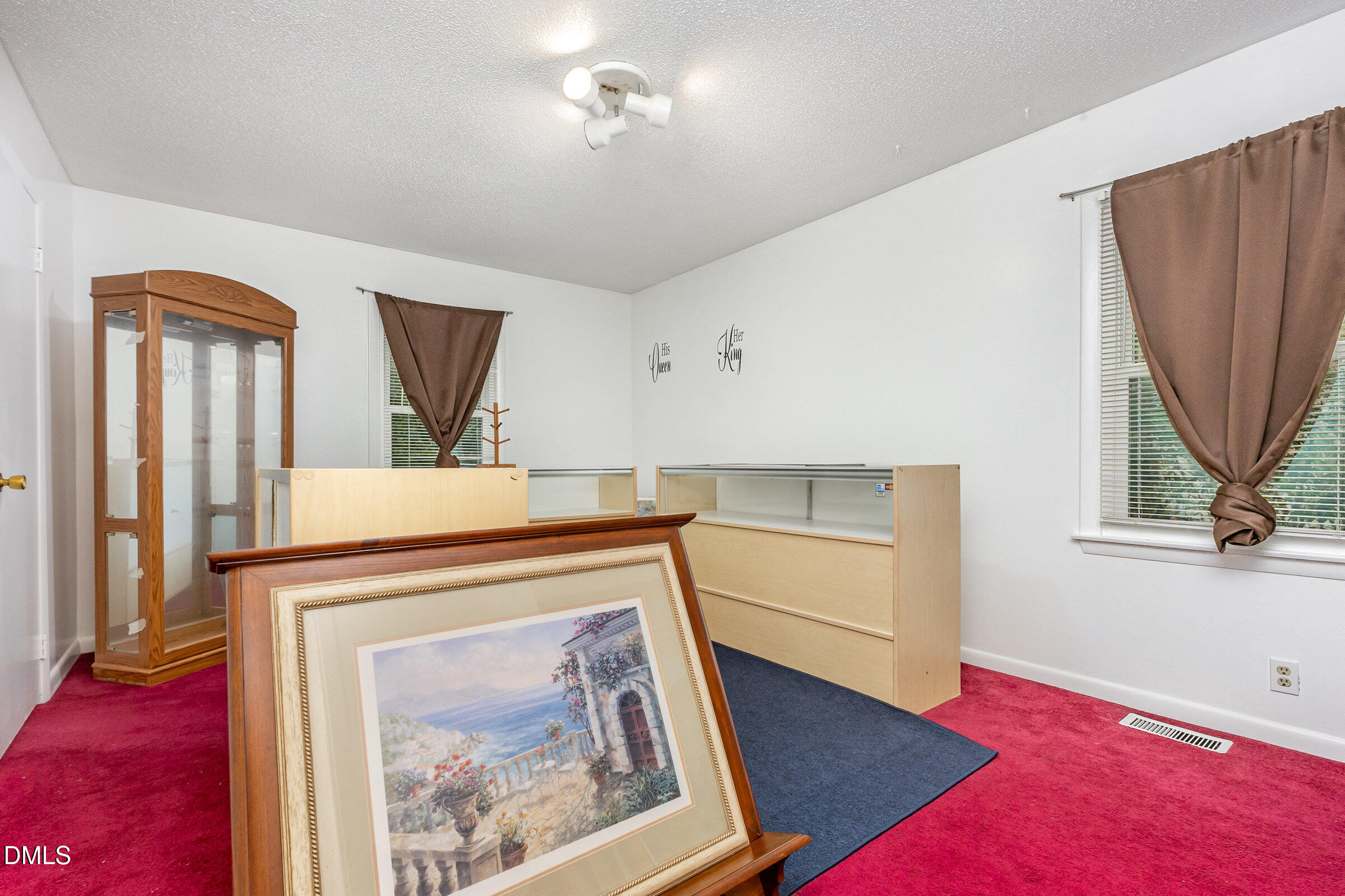 3228 Julian Drive Raleigh, NC 27604 - Photo 18 of 29 a view of a hallway with a fireplace and a chandelier