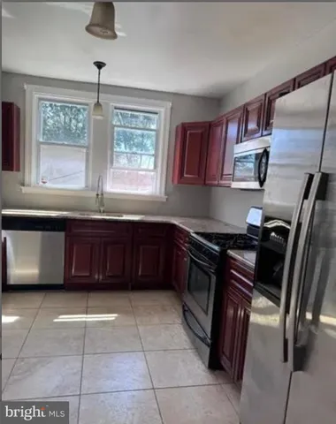 a kitchen with a stove a sink and a refrigerator