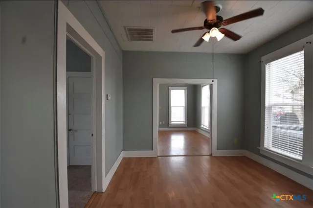 wooden floor in an empty room with a window