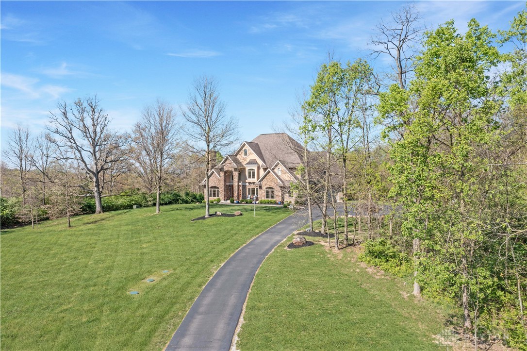 4096 Middle Urbana Road Urbana, OH 43078 - Photo 76 of 96 This spacious estate offers a sweeping driveway leading to a grand home nestled amongst lush greenery.