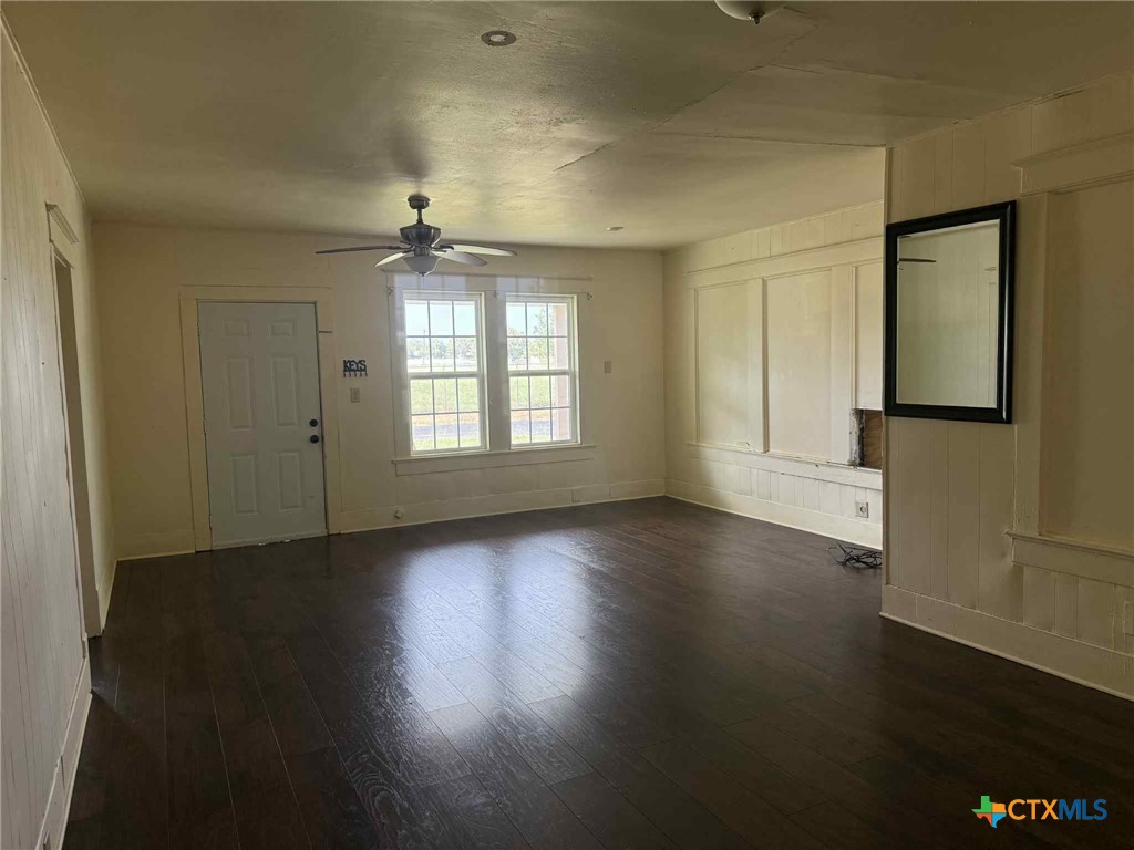 3003 Morgan Drive Victoria, TX 77901 - Photo 6 of 10 an empty room with wooden floor chandelier and windows