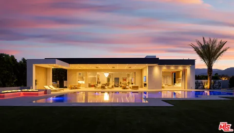 a view of a swimming pool with an outdoor seating