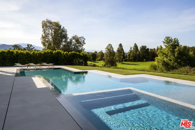 a view of a lake with a yard and trees