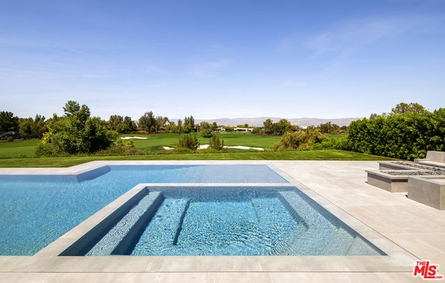 a view of swimming pool from a balcony