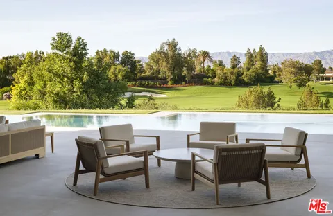a view of a chairs and table in patio
