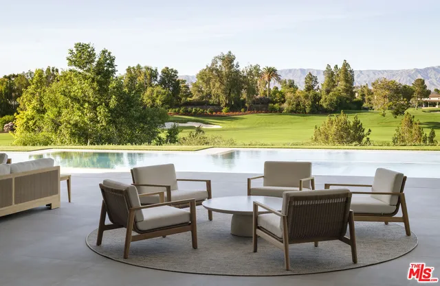 a view of a chairs and table in patio