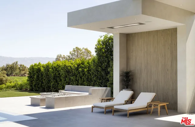 a view of a patio with a table and chairs