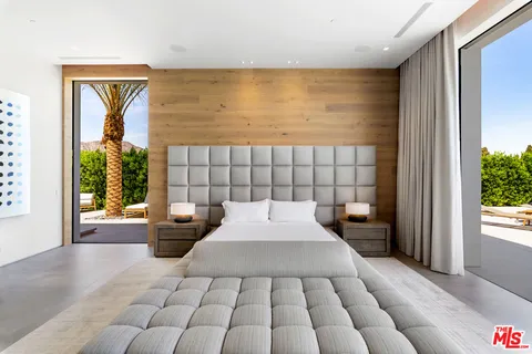 a large bedroom with a large bed and a large window