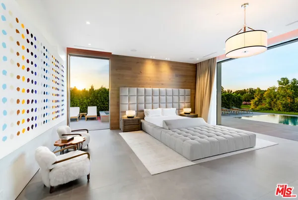 a bedroom with furniture and a large window