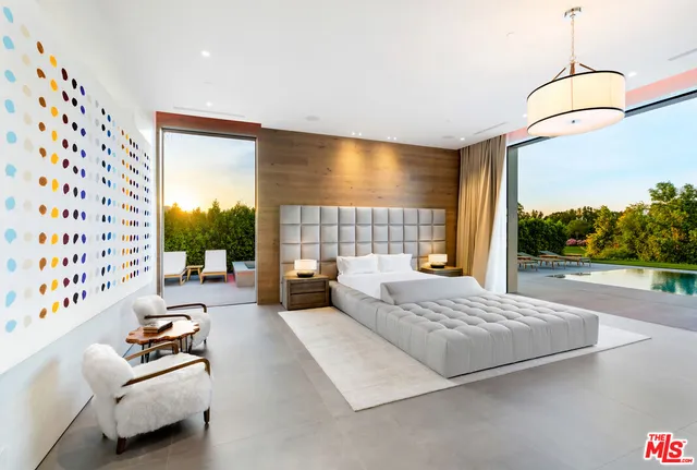 a bedroom with furniture and a large window