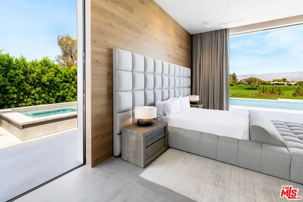 a bed room with a bed and a large window