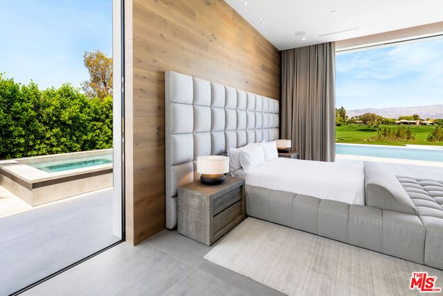 a bed room with a bed and a large window