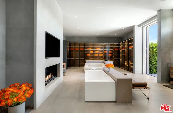 a room with furniture a flat screen tv and a fireplace