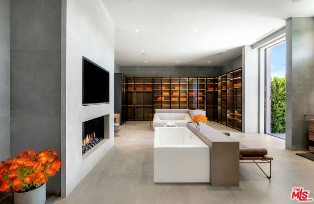 a room with furniture a flat screen tv and a fireplace