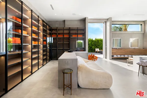 a living room with furniture a flat screen tv and a window