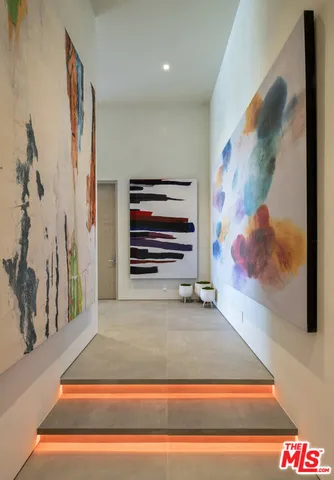 a large kitchen with kitchen island a sink a stove and a refrigerator