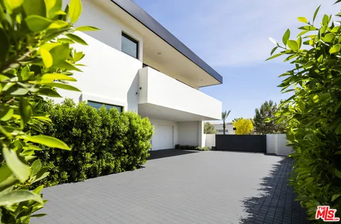 a view of a swimming pool with a patio and a yard