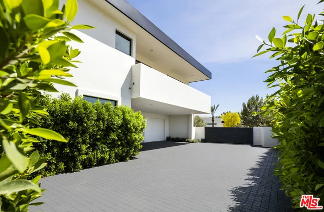 a view of a swimming pool with a patio and a yard