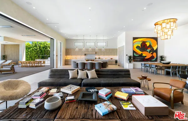 a living room with furniture and a floor to ceiling window