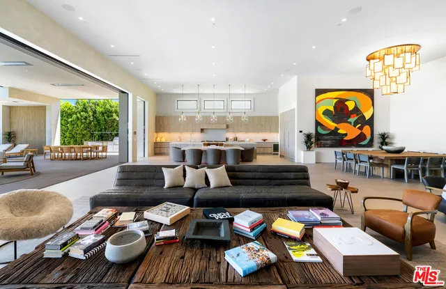 a living room with furniture and a floor to ceiling window