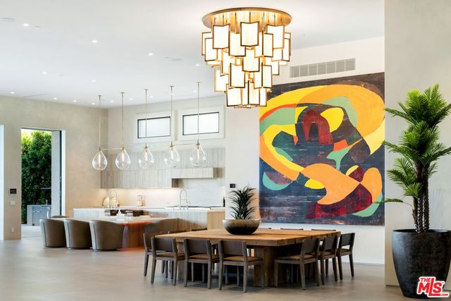 a view of a dining room with furniture and chandelier