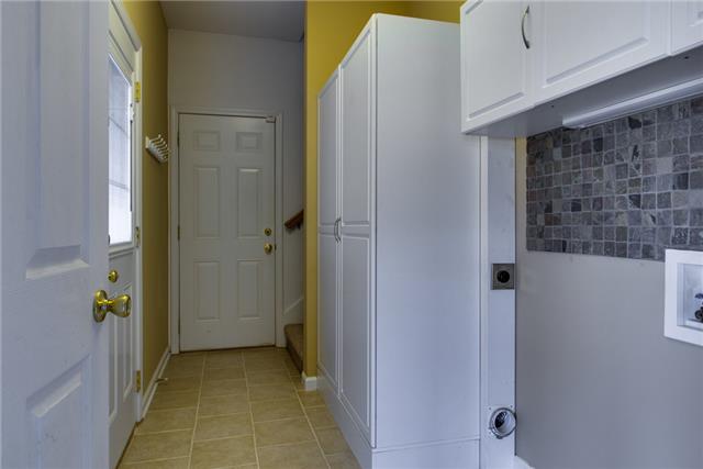 306 Eastside Road Burns, TN 37029 - Photo 17 of 19 More upgrades in this laundry room. Plenty of storage, a backsplash, and flooring.
