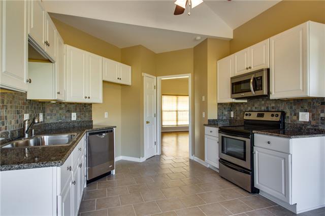 306 Eastside Road Burns, TN 37029 - Photo 5 of 19 This kitchen has been fully renovated: Tile flooring, Slate backsplash, white cabinets, granite countertop, stainless steel appliances, and a pantry.
