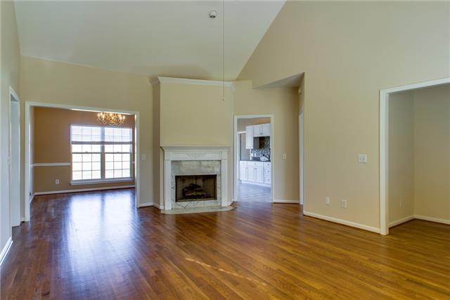 306 Eastside Road Burns, TN 37029 - Photo 9 of 19 The living room is central and open with a gas fireplace, high ceilings, and refinished hardwood floors.
