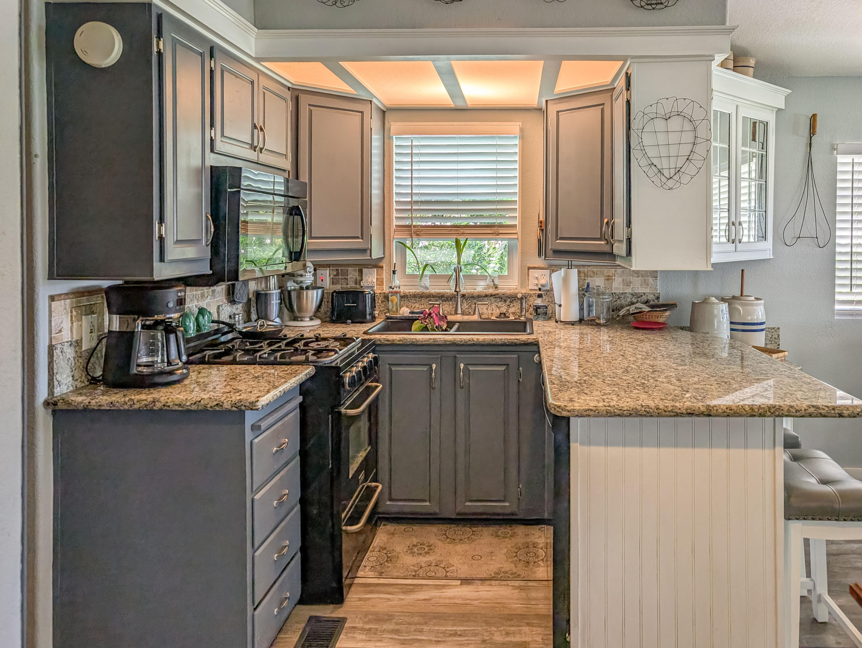 70200 Dillon Road, Unit 665 Desert Hot Springs, CA 92241 - Photo 14 of 40 a kitchen with stainless steel appliances granite countertop a sink stove and cabinets