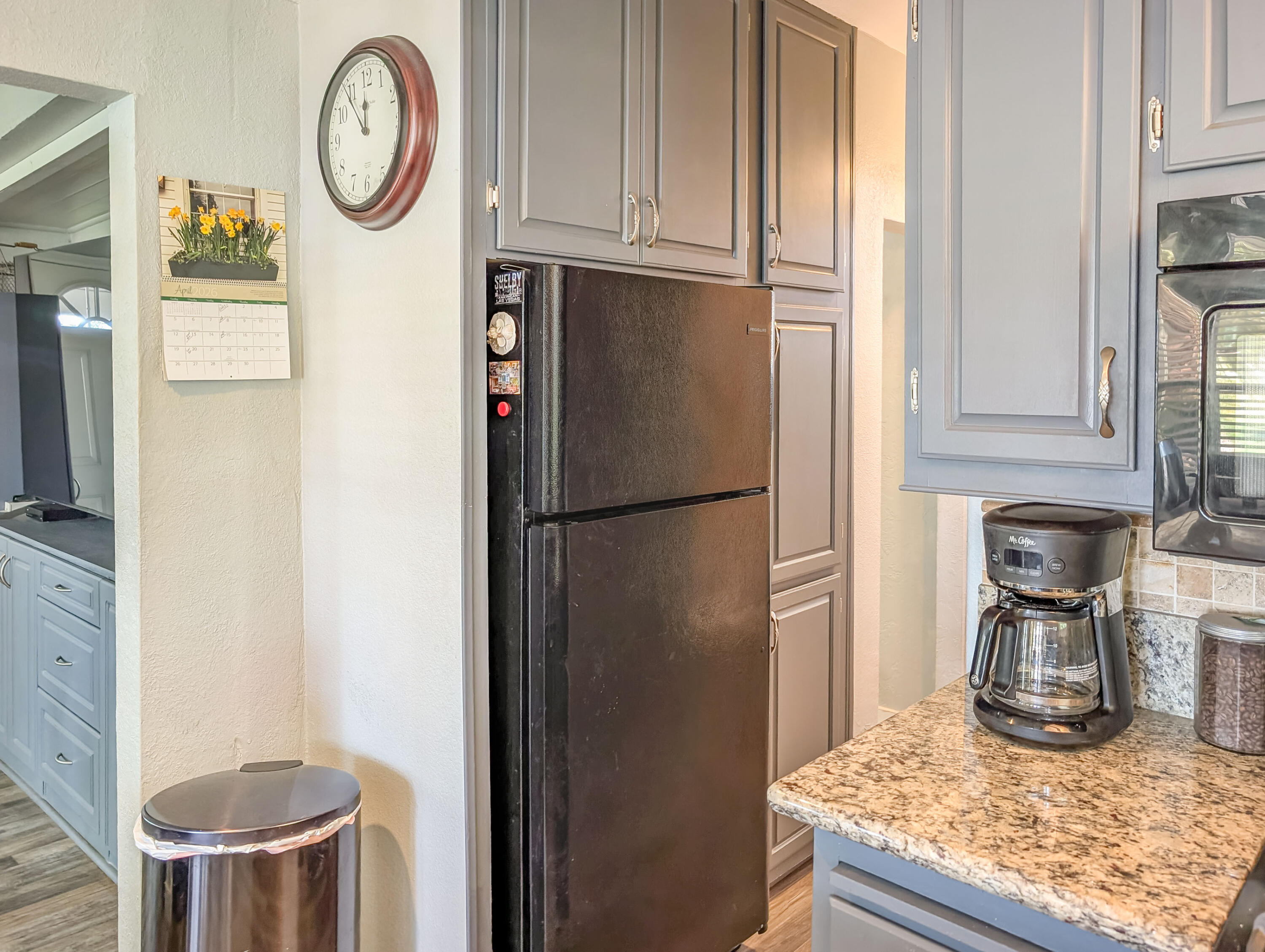 70200 Dillon Road, Unit 665 Desert Hot Springs, CA 92241 - Photo 16 of 40 a kitchen with a refrigerator and a stove top oven