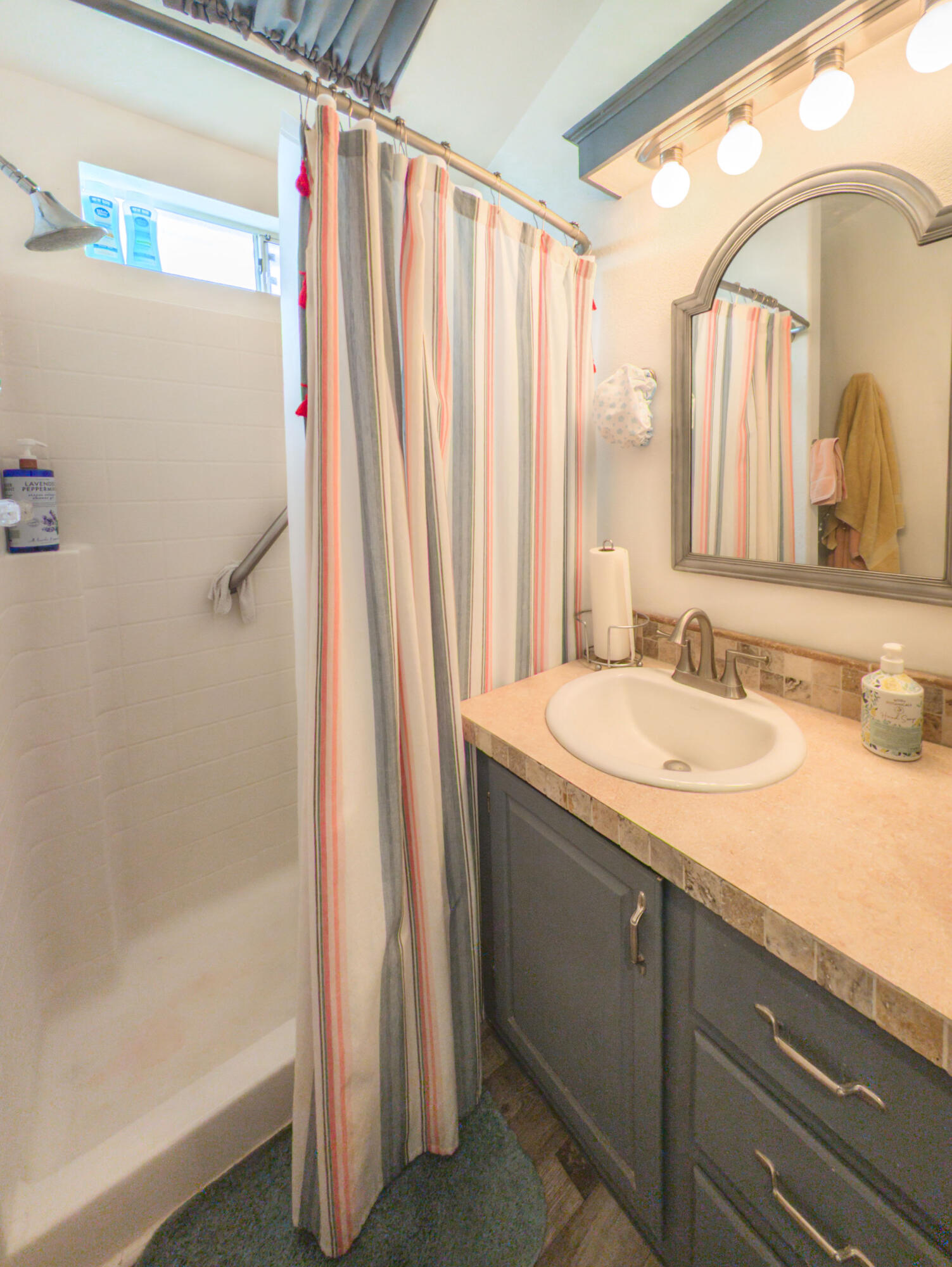 70200 Dillon Road, Unit 665 Desert Hot Springs, CA 92241 - Photo 17 of 40 a bathroom with a granite countertop sink and a mirror