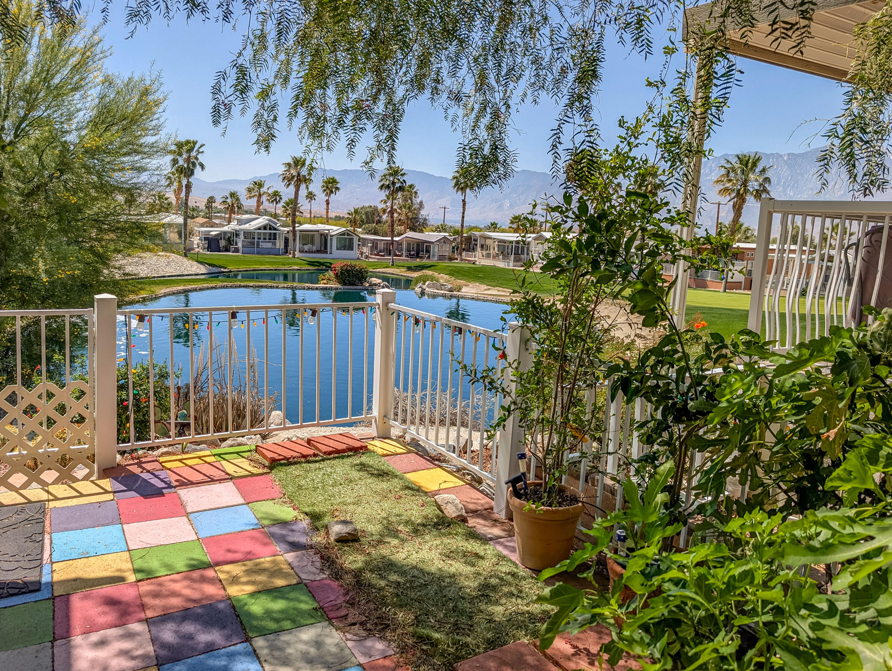 70200 Dillon Road, Unit 665 Desert Hot Springs, CA 92241 - Photo 33 of 40 a view of a backyard with a fountain and plants