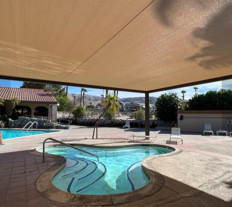 70200 Dillon Road, Unit 665 Desert Hot Springs, CA 92241 - Photo 38 of 40 a swimming pool with outdoor seating and outdoor seating