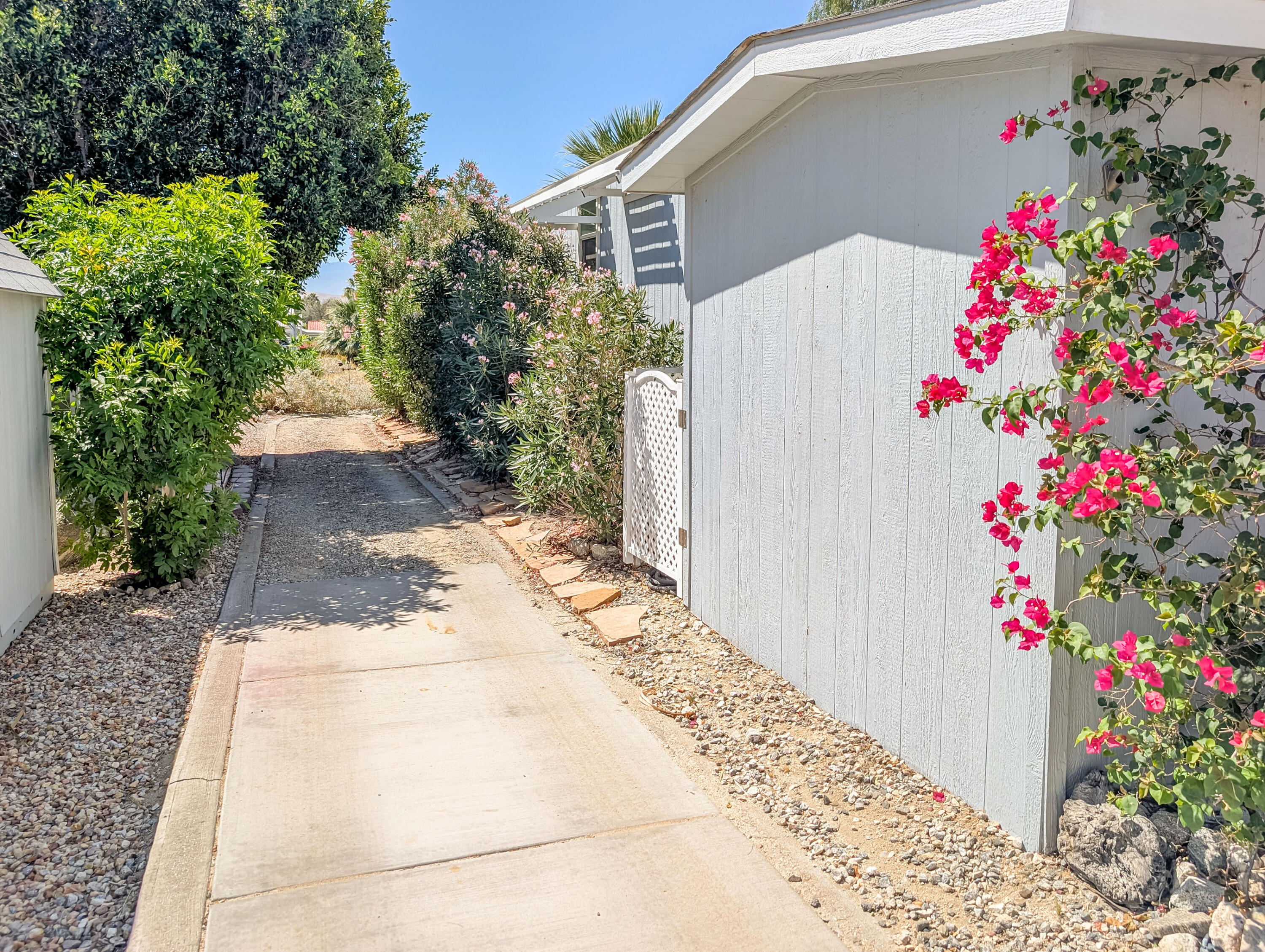 70200 Dillon Road, Unit 665 Desert Hot Springs, CA 92241 - Photo 4 of 40 a view of a flower arrangement in front of a house