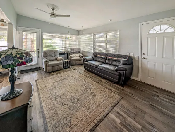 a living room with furniture and a potted plant
