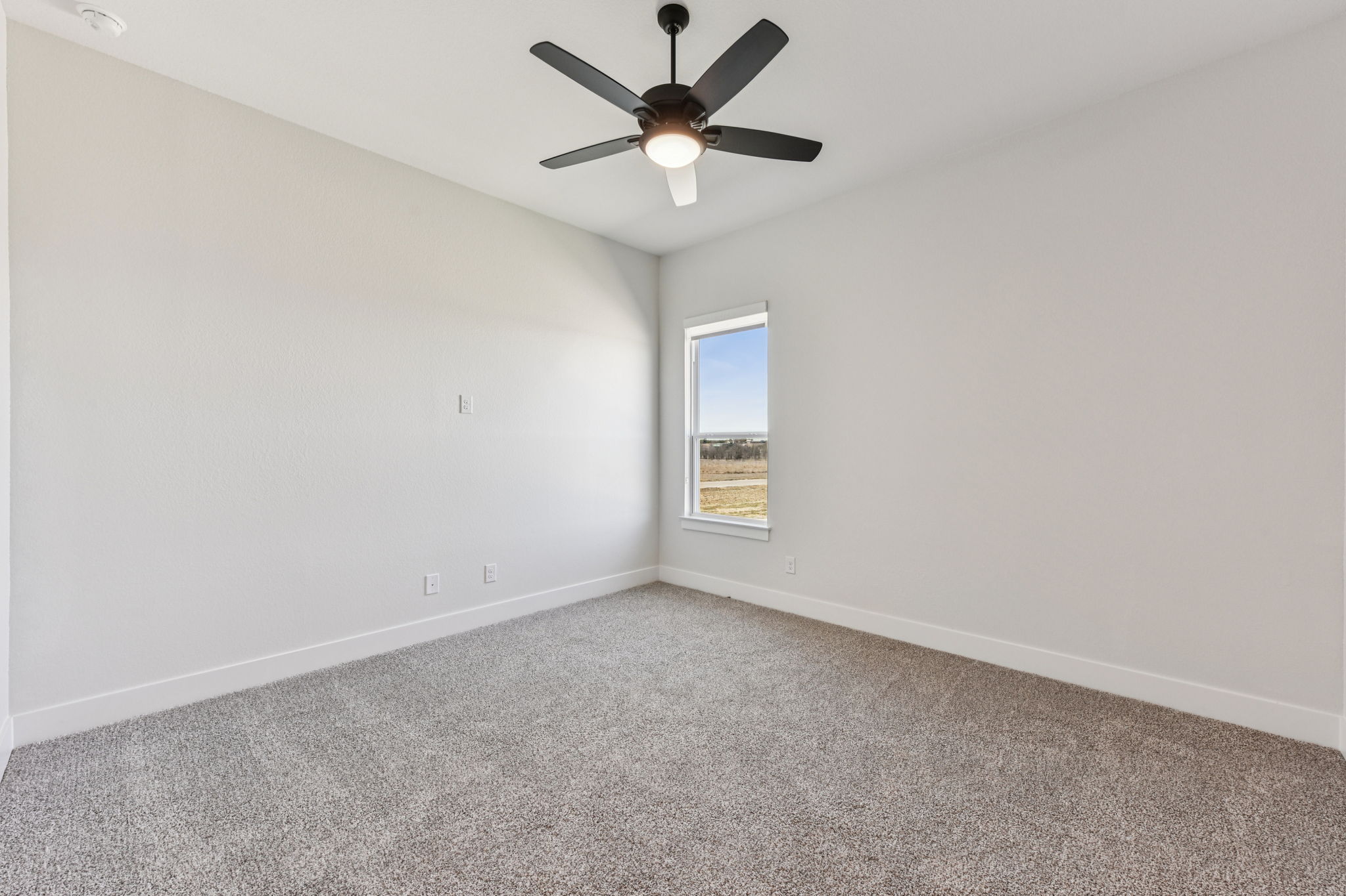 208 Winters Cove Georgetown, TX 78633 - Photo 16 of 37 an empty room with a window and a ceiling fan